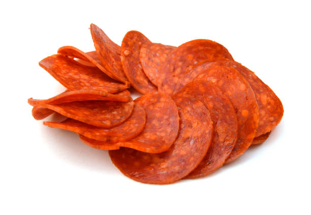 slices of pepperoni on white background