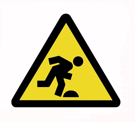 Caution, tripping hazard sign. Watch your steps.
