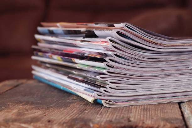 istock Old magazines on wooden table 1253899219