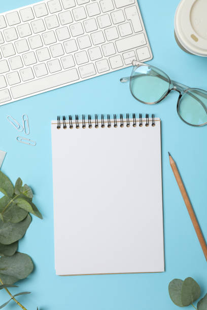 istock Composition with business accessories on blue background. Blogger workspace 1253899778