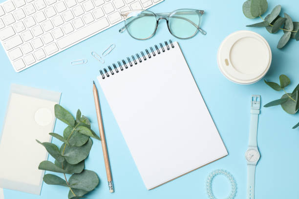 istock Composition with business accessories on blue background. Blogger workspace 1253899811