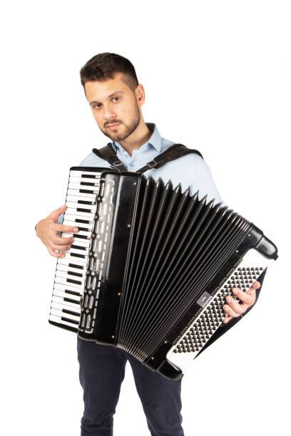 istock Young man playing accordion 1253900098