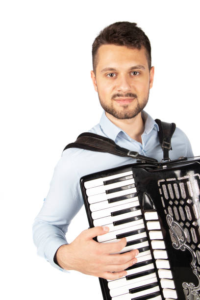 istock Young man playing accordion 1253900120