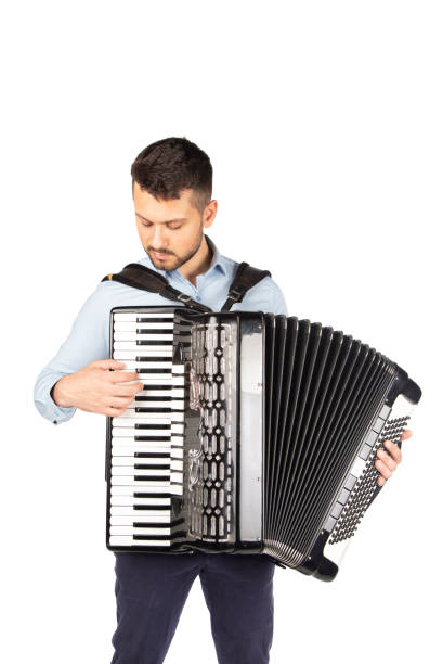 istock Young man playing accordion 1253900138