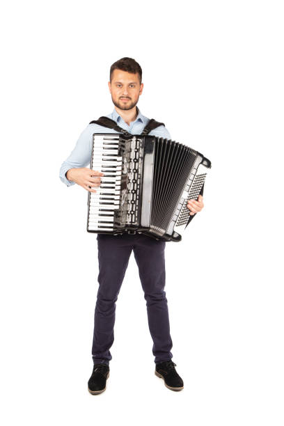 istock Young man playing accordion 1253900155
