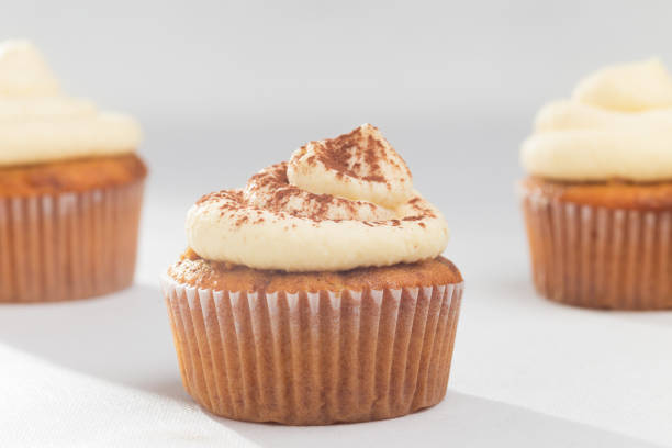 istock Tiramisu cupcake decorated with cocoa on white background 1253900239