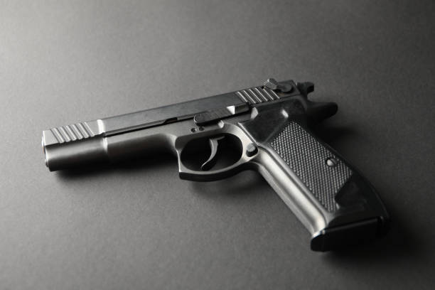 istock Pistol on black background. Self defense weapon 1253900997