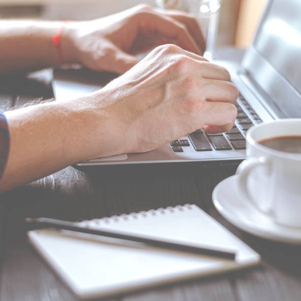 istock Home office workplace. Man analyzes and checking the graph on laptop 1253901356