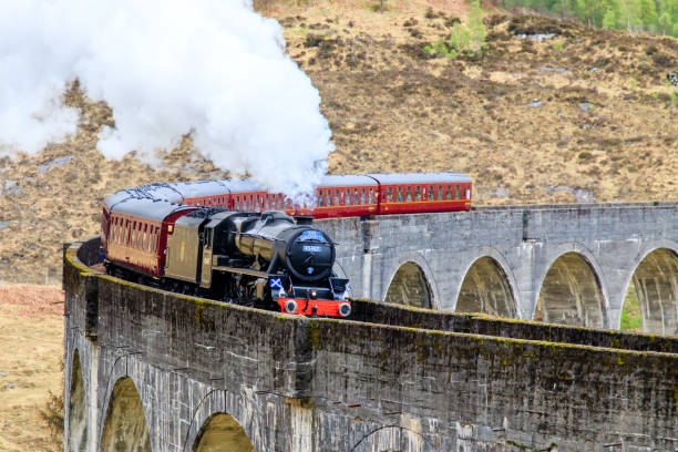 Jacobite steam Train Glenfinnan, Scotland - April 26, 2019: Jacobite Steam Train crossing the  famous Glenfinnan viaduct fort william stock pictures, royalty-free photos & images