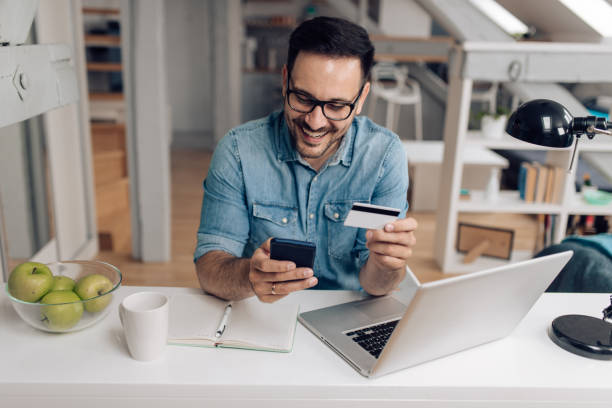 istock Happy young man making some online orders 1253904369