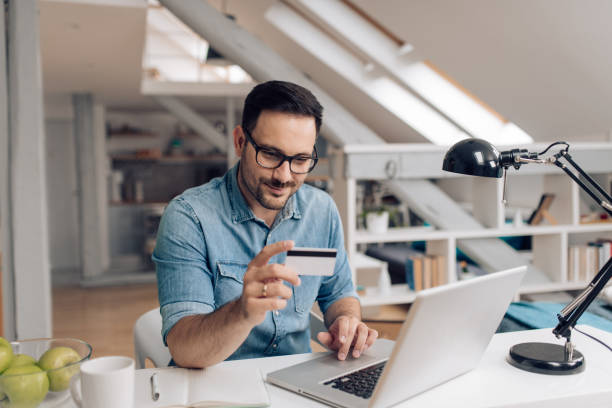 istock Man shopping online at his home office 1253904370
