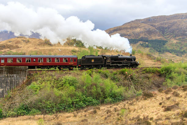 Jacobite steam Train Glenfinnan, Scotland - April 26, 2019: Jacobite Steam Train crossing the  famous Glenfinnan viaduct fort william stock pictures, royalty-free photos & images