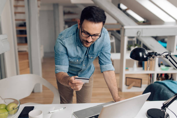 istock Man banking online from his home office 1253904384