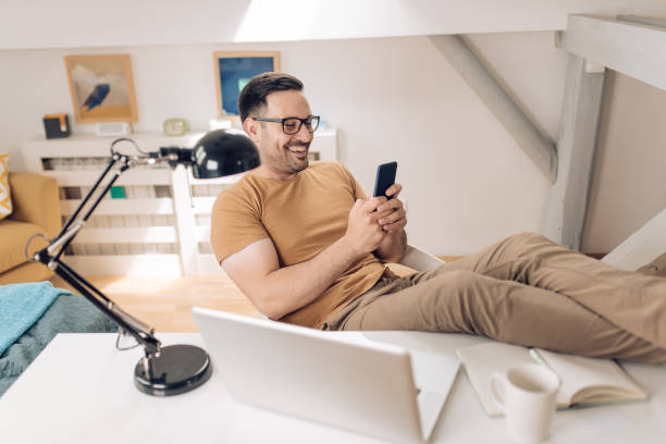 istock Man enjoying at his home office after work 1253904458