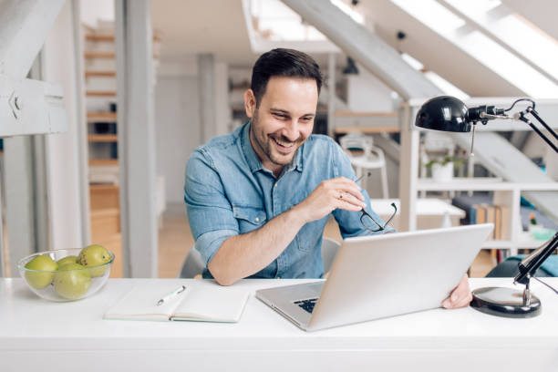 istock Young businessman enjoying working from home 1253904493