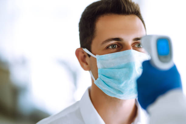 istock Visitors must go through fever measures using infrared digital thermometer check temperature measurement on the forehead. 1253907127