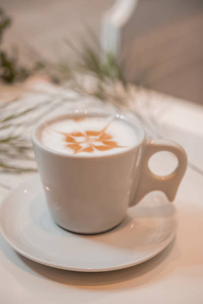 istock coffee latte art in a clean coffee shop with  White cup and selective  focus 1253910450