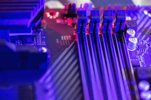 istock DDR4 RAM. Close-up of empty four Slots for ddr4 RAM, random access memory stick slots with a neon lilac and purple backlight. Power to the motherboard. Socket am4. 1253912147