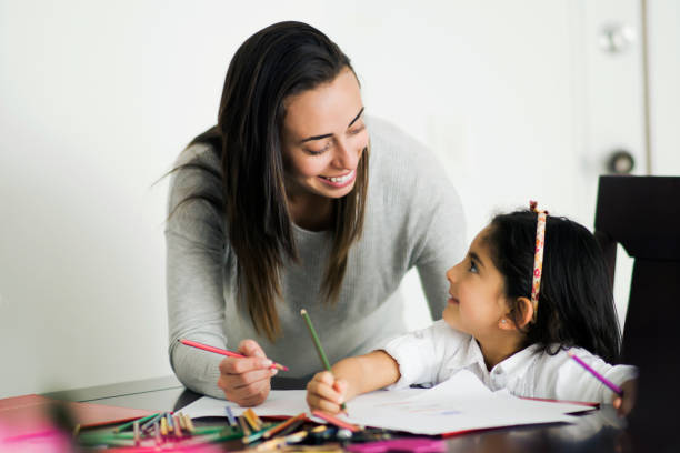 istock Loving mother and daughter talking about her school assignment during lockdown 1253914032