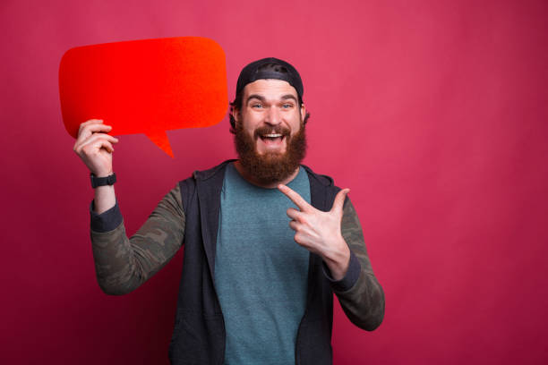 istock Excited bearded man is pointing at a red cloud he is holding 1253914164