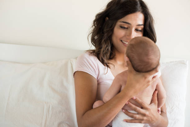 istock Mother holding newborn baby 1253918766