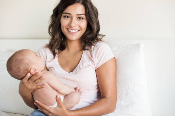 istock Mother holding newborn baby 1253918774