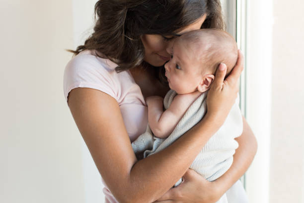 istock Woman with newborn baby 1253919314
