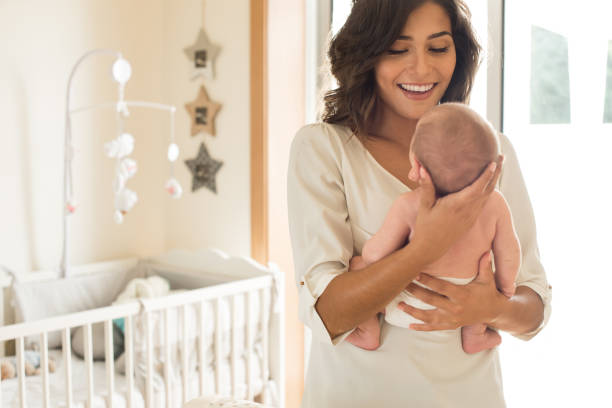 istock Mother with baby in arms 1253920195