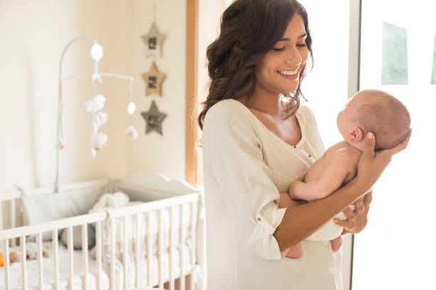 istock Mother with baby in arms 1253920208