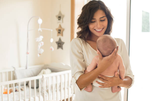 istock Mother with baby in arms 1253920214