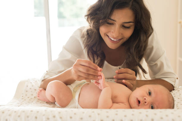 istock Mother moisturizing baby 1253920220