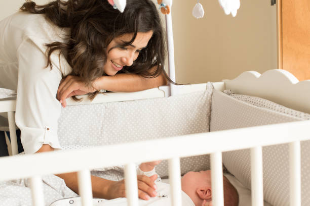 istock Mother putting baby to sleep 1253920227