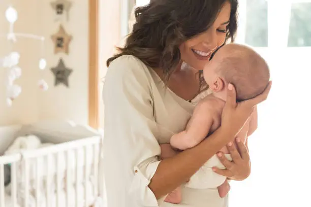 Photo of Mother with baby in arms