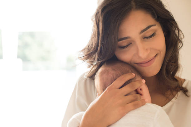istock Woman with newborn baby 1253920270