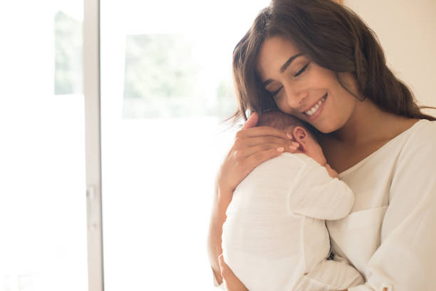 istock Woman with newborn baby 1253920272