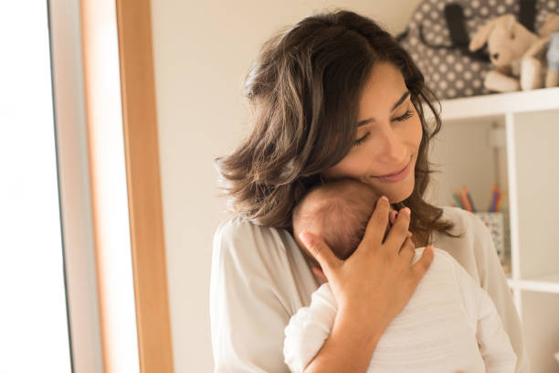 istock Woman with newborn baby 1253920276