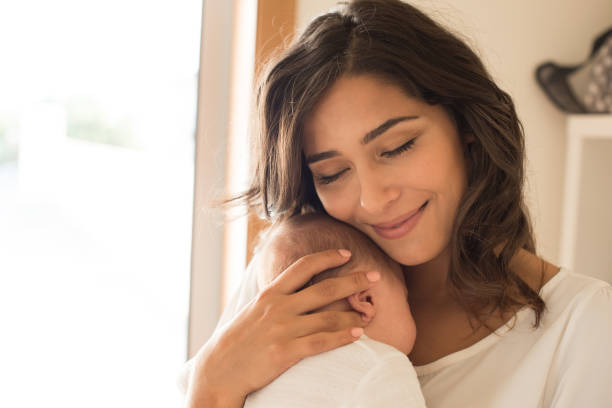 istock Woman with newborn baby 1253920280