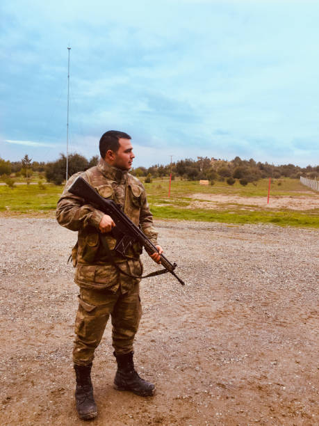 istock soldier on guard with rifle 1253921903