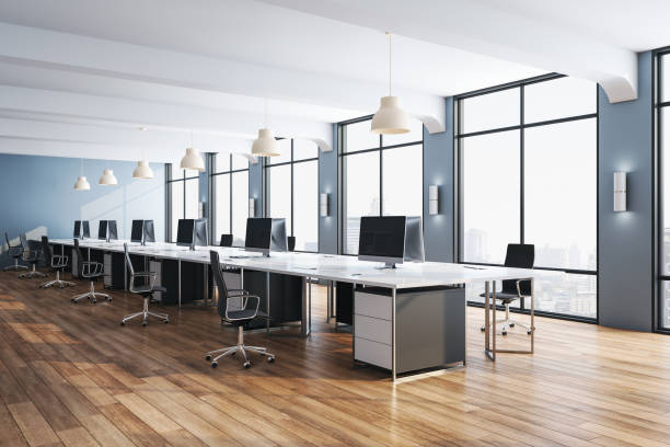 istock Minimalistic office interior room with computers and wooden floor. 1253923182