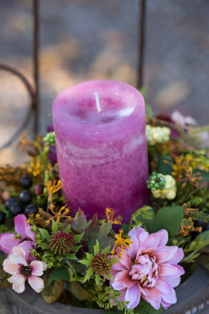 istock Pink candle in a wreath decorated with flower bloom 1253923857