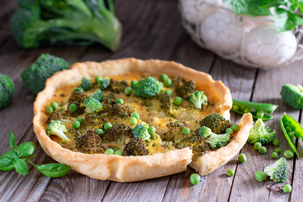 istock Pie with broccoli and green peas on a wooden board on the table. 1253924954