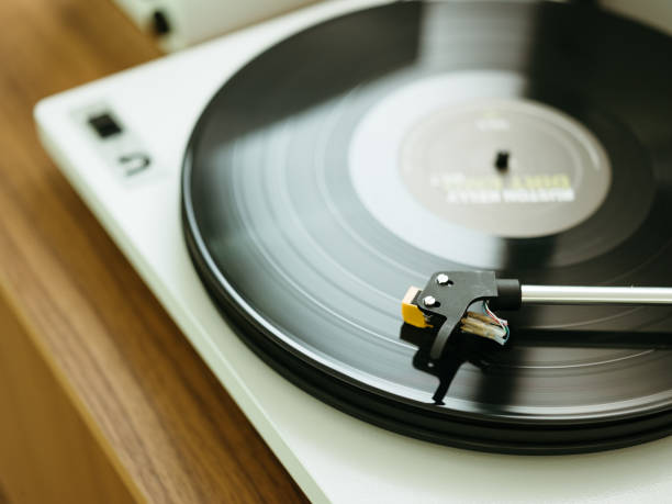 istock Modern record player playing a vinyl on a wood table. 1253926229