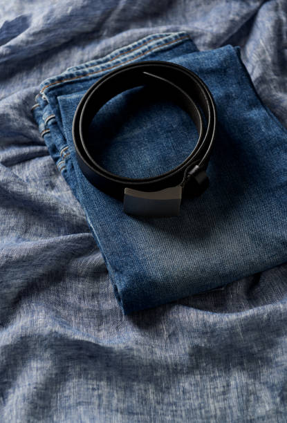 istock Jeans trousers on blue background. Top view. Copy space. 1253926273