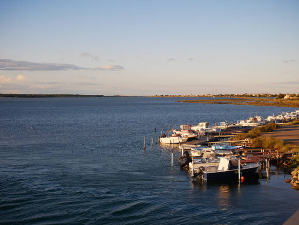 istock Small motor boats on a small port 1253926582