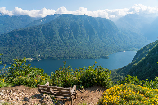 High angle view of famous bench over the panorama Lake Bohinj and the mountains around.