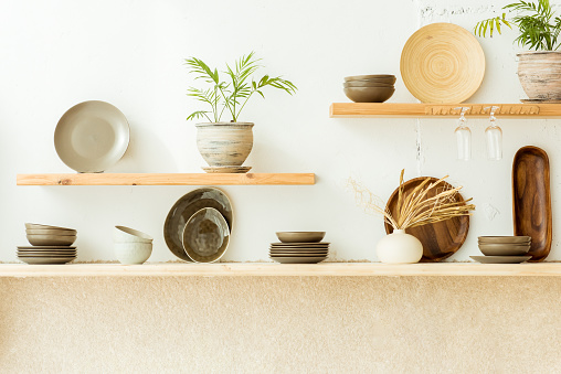 Wooden stand on kitchen table with decoration and copy space