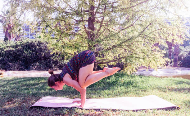 istock GIRL MAKING YOGA POSES grass 1253930957