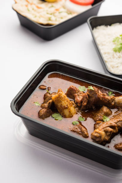 istock Mutton Masala Curry in plastic container for home delivery 1253933597