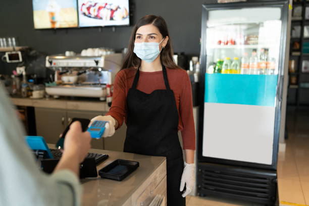 istock Barista Receiving Payment From Customer At Counter 1253933770
