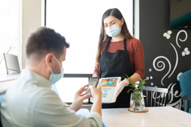 istock Waitress Showing Contactless Menu To Customer 1253934004